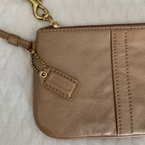 Coach wristlet. Neutral color with a shimmer. Never used!